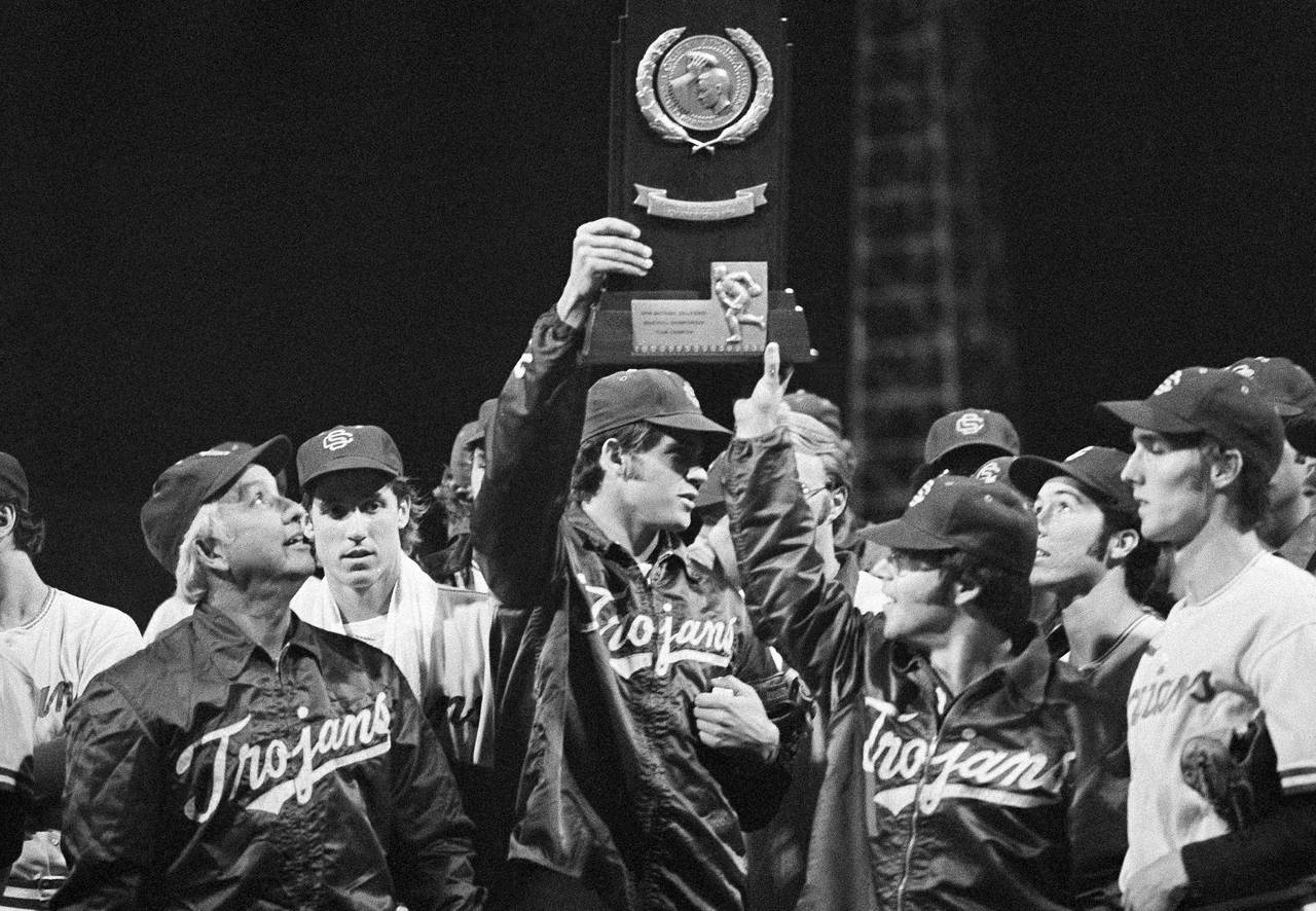 FILE - University of Southern California head coach Rod Dedeaux, left, proudly looks at the NCAA co...