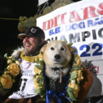 
              FILE - Iditarod winner Brent Sass poses for photos with lead dogs Morello, left, and Slater after winning the Iditarod Trail Sled Dog Race in Nome, Alaska, March 15, 2022. Only 33 mushers will participate in the ceremonial start of the Iditarod Trail Sled Dog Race on Saturday, March 4, the smallest field ever. (Anne Raup/Anchorage Daily News via AP)
            