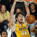 
              FILE - Los Angeles Lakers' Pau Gasol (16), of Spain, dunks as San Antonio Spurs' Manu Ginobili, left, of Argentina, looks on during the second half of Game 5 of the NBA Western Conference basketball finals in Los Angeles, May 29, 2008. Gasol was announced Friday, Feb. 17, 2023, as being among the finalists for enshrinement later this year by the Basketball Hall of Fame. The class will be revealed on April 1. (AP Photo/Chris Pizzello, File)
            