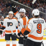 
              Philadelphia Flyers' Noah Cates (49) and Ivan Provorov (9) celebrate a goal against the Edmonton Oilers during the first period of an NHL hockey game Tuesday, Feb. 21, 2022, in Edmonton, Alberta. (Jason Franson/The Canadian Press via AP)
            