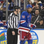 
              Linesman Kilian McNamara (93) escorts New York Rangers' K'Andre Miller (79) off the ice after Miller received a penalty during the first period of an NHL hockey game against the Los Angeles Kings, Sunday, Feb. 26, 2023, in New York. (AP Photo/Frank Franklin II)
            