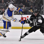 
              Buffalo Sabres center Tage Thompson, left, shoots against a stickless Los Angeles Kings center Anze Kopitar during the first period of an NHL hockey game in Los Angeles, Monday, Feb. 13, 2023. (AP Photo/Alex Gallardo)
            