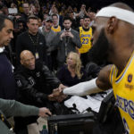 
              Los Angeles Lakers forward LeBron James, right, shakes hands with Kareem Abdul-Jabbar, center, after James beat Abdul-Jabbar's record to become the NBA's all-time leading scorer during the second half of an NBA basketball game against the Oklahoma City Thunder Tuesday, Feb. 7, 2023, in Los Angeles. (AP Photo/Ashley Landis)
            