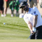 
              Adam Hadwin chips to the ninth green during the first round of the Phoenix Open golf tournament Thursday, Feb. 9, 2023, in Scottsdale, Ariz. Hadwin finished at five under par and is tied for the lead. (AP Photo/Darryl Webb)
            