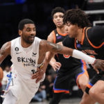 
              Brooklyn Nets guard Kyrie Irving (11) drives against New York Knicks center Jericho Sims during the second half of an NBA basketball game, Saturday, Jan. 28, 2023, in New York. The Nets won 122-115. (AP Photo/Mary Altaffer)
            