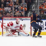 
              Detroit Red Wings goalie Ville Husso (35) gives up a goal to Edmonton Oilers' Connor McDavid (97) during the shootout in an NHL hockey game Wednesday, Feb. 15, 2023, in Edmonton, Alberta. (Jason Franson/The Canadian Press via AP)
            