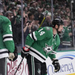 
              Dallas Stars' Jamie Benn (14) and Jani Hakanpaa (2) skate to the bench after celebrating a goal scored by Benn in the first period of an NHL hockey game against the Chicago Blackhawks, Wednesday, Feb. 22, 2023, in Dallas. (AP Photo/Tony Gutierrez)
            