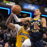 
              Indiana Pacers guard Tyrese Haliburton (0) shoots in front of Los Angeles Lakers forward Anthony Davis (3) during the second half of an NBA basketball game in Indianapolis, Thursday, Feb. 2, 2023. The Lakers defeated the Pacers 112-111. (AP Photo/Michael Conroy)
            