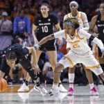 
              South Carolina guard Zia Cooke, left, falls to the floor as she battles for the ball with Tennessee guard Jordan Horston (25) during the second half of an NCAA college basketball game, Thursday, Feb. 23, 2023, in Knoxville, Tenn. (AP Photo/Wade Payne)
            