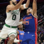 
              Boston Celtics forward Jayson Tatum (0) attempts a layup as Detroit Pistons guard Killian Hayes (7) defends during the first half of an NBA basketball game, Monday, Feb. 6, 2023, in Detroit. (AP Photo/Carlos Osorio)
            
