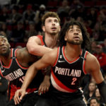 
              Portland Trail Blazers forward Nassir Little, left, and Trendon Watford, right, battle with Houston Rockets center Alperen Sengun, center, for position under the basket during the first half of an NBA basketball game in Portland, Ore., Sunday, Feb. 26, 2023. (AP Photo/Steve Dykes)
            