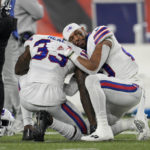 
              FILE - Buffalo Bills' Siran Neal (33) and Nyheim Hines react after teammate Damar Hamlin was injured during the first half of an NFL football game against the Cincinnati Bengals, Monday, Jan. 2, 2023, in Cincinnati. On Jan. 2, a religious undercurrent was thrust into the NFL spotlight when Buffalo Bills safety Damar Hamlin collapsed during a crucial game with Cincinnati. Those watching witnessed players praying on the field as medics worked to save Hamlin’s life.(AP Photo/Jeff Dean, File)
            
