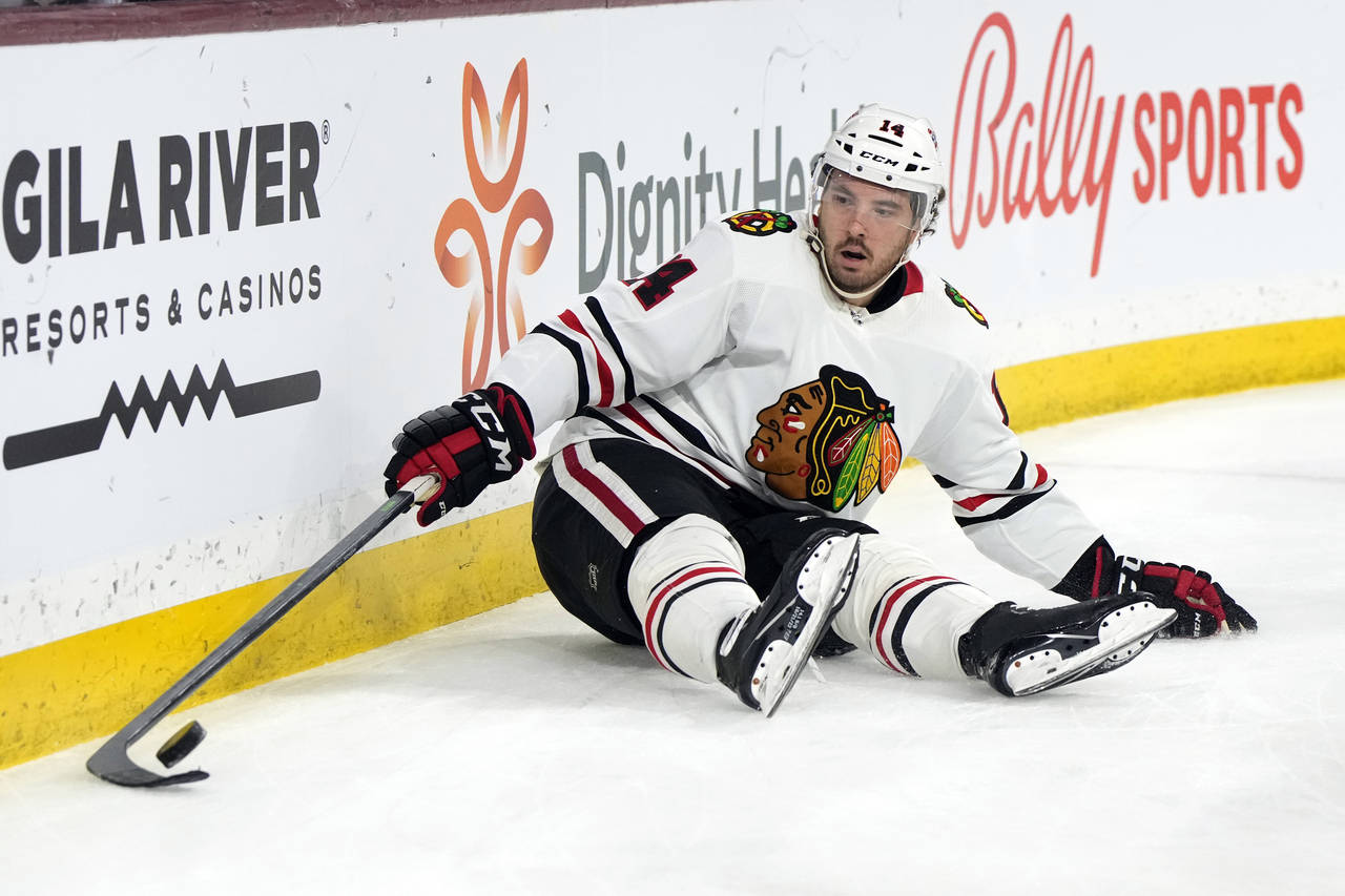 Chicago Blackhawks left wing Boris Katchouk tries to gather the puck after falling down in the seco...