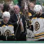 
              Boston Bruins head coach Jim Montgomery, center, talks with a coach nearby during the first period of an NHL hockey game against the Dallas Stars, Tuesday, Feb. 14, 2023, in Dallas. (AP Photo/Tony Gutierrez)
            