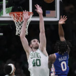 
              Boston Celtics center Luke Kornet (40) tries to block a shot by Philadelphia 76ers guard Tyrese Maxey (0) during the first half of an NBA basketball game, Wednesday, Feb. 8, 2023, in Boston. (AP Photo/Charles Krupa)
            