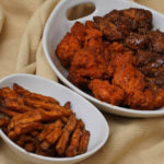 
              "Boneless chicken wings", with two sauces, and an order of sweet potato fries, from a restaurant in New York, are shown in this photo, Wednesday, Feb. 8, 2023. With the Super Bowl at hand, behold the untruth that has been perpetrated upon (and with the full blessing of) the chicken-consuming citizens of the United States: A “boneless wing” isn’t a wing at all. (AP Photo/Richard Drew)
            