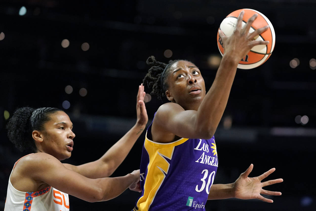 FILE - Los Angeles Sparks forward Nneka Ogwumike, right, tries to shoot as Connecticut Sun forward ...