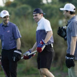 
              Columbus Blue Jackets left wing Johnny Gaudreau, left, Nick Suzuki, of the Montreal Canadiens, and Dallas Star left wing Jason Robertson, right, talk on the green before putting with their hockey sticks on a golf skills competition, Wednesday, Feb. 1, 2023, in Plantation, Fla. The event was part of the NHL All Star weekend. (AP Photo/Marta Lavandier)
            