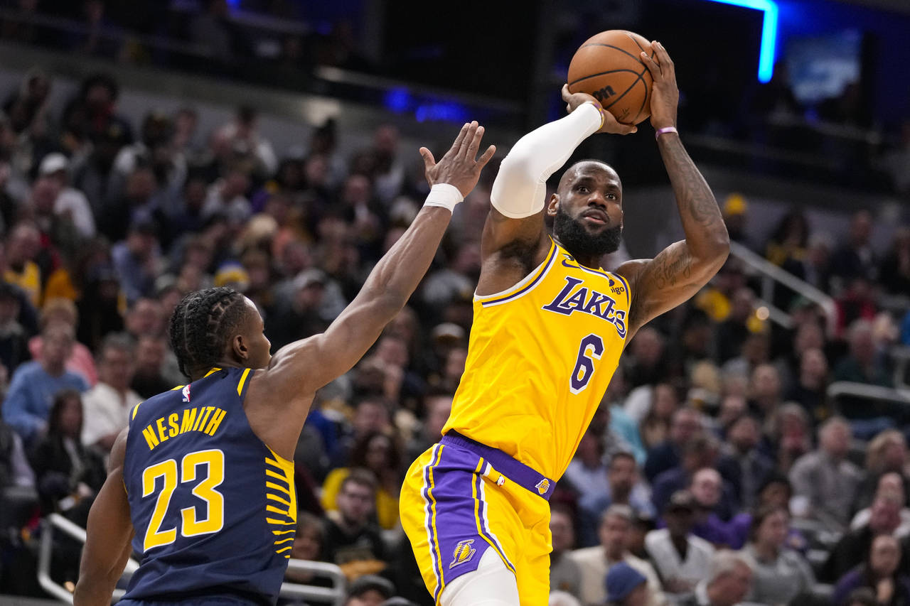 Los Angeles Lakers forward LeBron James (6) shoots over Indiana Pacers forward Aaron Nesmith (23) d...