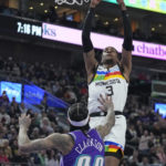 
              Minnesota Timberwolves forward Jaden McDaniels (3) goes to the basket as Utah Jazz guard Jordan Clarkson (00) defends during the first half of an NBA basketball game Wednesday, Feb. 8, 2023, in Salt Lake City. (AP Photo/Rick Bowmer)
            