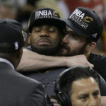 
              FILE - Cleveland Cavaliers forward LeBron James, back left, is hugged by Kevin Love after Game 7 of basketball's NBA Finals against the Golden State Warriors in Oakland, Calif., Sunday, June 19, 2016. Cavaliers forward Love, in an essay for The Associated Press, reflected on his years as  James' teammate. James is about to pass Kareem Abdul-Jabbar for the NBA career scoring record. (AP Photo/Marcio Jose Sanchez, File)
            