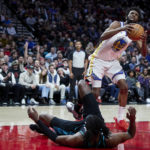 
              Golden State Warriors forward Andrew Wiggins (22) looks to shoot over Portland Trail Blazers forward Jerami Grant during the first half of an NBA basketball game in Portland, Ore., Wednesday, Feb. 8, 2023. (AP Photo/Craig Mitchelldyer)
            
