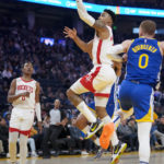 
              Houston Rockets forward Kenyon Martin Jr. shoots next to Golden State Warriors forward Donte DiVincenzo, right, during the first half of an NBA basketball game in San Francisco, Friday, Feb. 24, 2023. (AP Photo/Godofredo A. Vásquez)
            