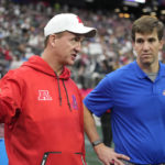
              AFC coach Peyton Manning, left, talks with NFC coach Eli Manning during the flag football event at the NFL Pro Bowl, Sunday, Feb. 5, 2023, in Las Vegas. (AP Photo/John Locher)
            