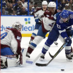 
              Colorado Avalanche defenseman Erik Johnson (6) gives Tampa Bay Lightning center Brayden Point (21) a shove as he tries to get a shot off on goaltender Alexandar Georgiev (40) during the second period of an NHL hockey game Thursday, Feb. 9, 2023, in Tampa, Fla. (AP Photo/Chris O'Meara)
            