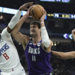 
              Milwaukee Bucks' Brook Lopez drives between Los Angeles Clippers' Marcus Morris Sr. and Nicolas Batum during the first half of an NBA basketball game Thursday, Feb. 2, 2023, in Milwaukee. (AP Photo/Morry Gash)
            