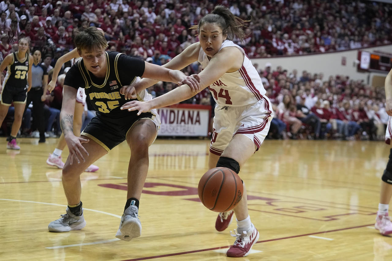 Purdue's Rickie Woltman (35) and Indiana's Mackenzie Holmes (54) battle for a loose ball during the...