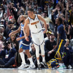
              Denver Nuggets forward Michael Porter Jr. reacts after hitting a 3-point basket against the Minnesota Timberwolves in the first half of an NBA basketball game Tuesday, Feb. 7, 2023, in Denver. (AP Photo/David Zalubowski)
            
