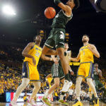 
              Michigan State forward Malik Hall dunks during the first half of an NCAA college basketball game against Michigan, Saturday, Feb. 18, 2023, in Ann Arbor, Mich. (AP Photo/Carlos Osorio)
            