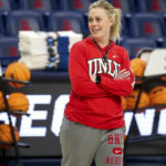 
              UNLV coach Lindy La Rocque smiles while watching the team shoot layups during practice for the NCAA women's college basketball tournament in Tucson, Ariz., March 18, 2022. (Rebecca Sasnett/Arizona Daily Star via AP)
            