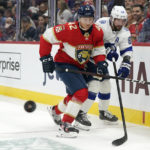 
              Florida Panthers defenseman Gustav Forsling (42) and Tampa Bay Lightning right wing Nikita Kucherov (86) battle for the puck during the first period of an NHL hockey game, Monday, Feb. 6, 2023, in Sunrise, Fla. (AP Photo/Wilfredo Lee)
            