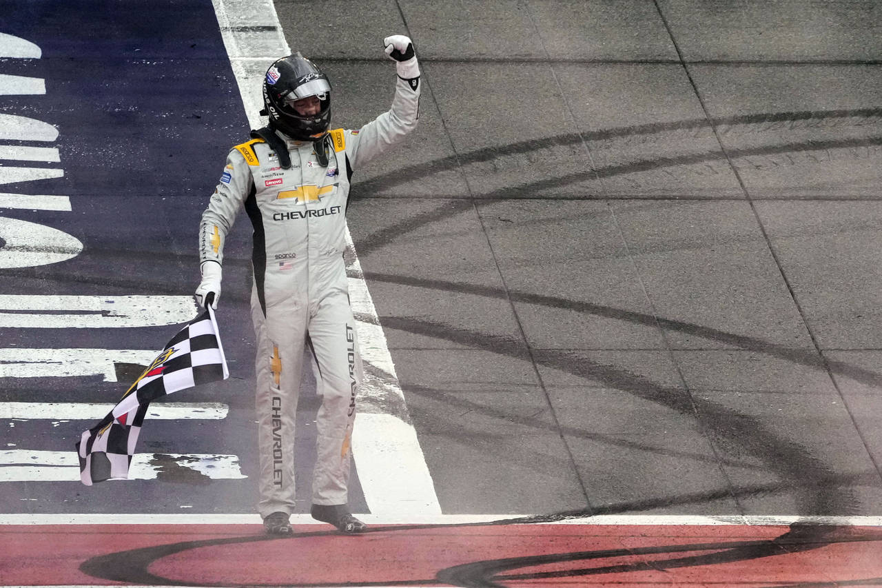 Kyle Busch celebrates after winning a NASCAR Cup Series auto race at Auto Club Speedway in Fontana,...