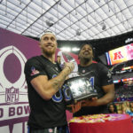 
              NFC tight end George Kittle, left, of the San Francisco 49ers, and defensive end Cameron Jordan of the New Orleans Saints hold the trophy after the NFC defeated AFC at the NFL Pro Bowl games, Sunday, Feb. 5, 2023, in Las Vegas(AP Photo/John Locher)
            