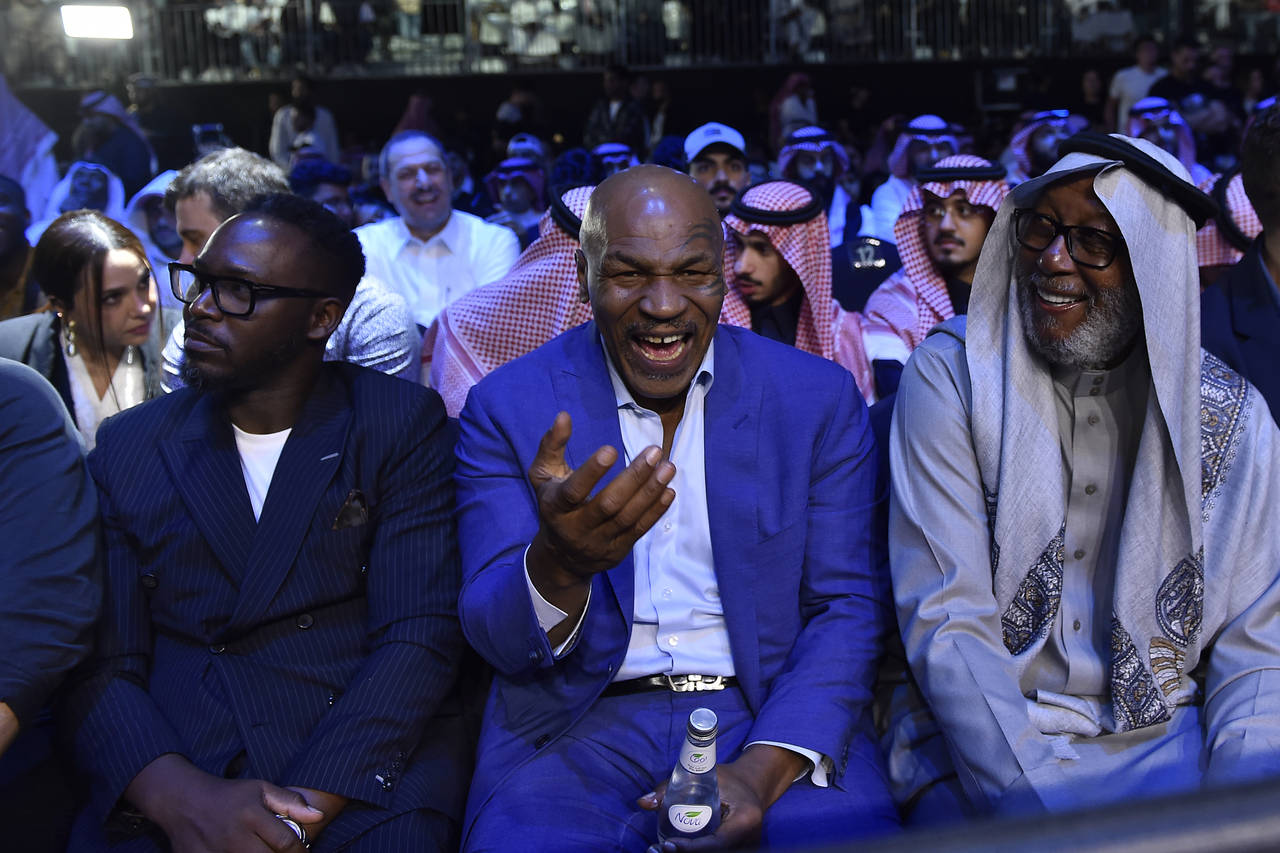 Mike Tyson, center, attends the boxing match between Jake Paul and Tommy Fury in Riyadh, Saudi Arab...