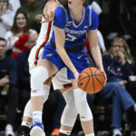 
              Creighton's Lauren Jensen, front looks to pass under pressure from UConn's Nika Muhl during the second half of an NCAA college basketball game Wednesday, Feb. 15, 2023, in Storrs, Conn. (AP Photo/Jessica Hill)
            