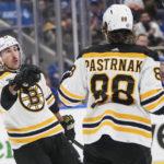 
              Boston Bruins' Brad Marchand (63) celebrates with David Pastrnak (88) after scoring a goal during the third period of an NHL hockey game against the New York Islanders Wednesday, Jan. 18, 2023, in Elmont, N.Y. The Bruins won 4-1. (AP Photo/Frank Franklin II)
            