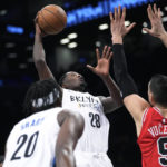 
              Brooklyn Nets forward Dorian Finney-Smith (28) goes to the basket against Chicago Bulls center Nikola Vucevic (9) during the first half of an NBA basketball game Thursday, Feb. 9, 2023, in New York. (AP Photo/Mary Altaffer)
            