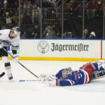 
              New York Rangers goaltender Igor Shesterkin, right, stops a shot on goal by Los Angeles Kings' Adrian Kempe (9) during the first period of an NHL hockey game Sunday, Feb. 26, 2023, in New York. (AP Photo/Frank Franklin II)
            