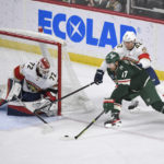 
              Minnesota Wild left wing Marcus Foligno (17) tries to sweep the puck past Florida Panthers goalie Sergei Bobrovsky (72) and defenseman Gustav Forsling (42) during the first period of an NHL hockey game, Monday, Feb. 13, 2023, in St. Paul, Minn. (AP Photo/Craig Lassig)
            