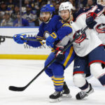
              Buffalo Sabres center Vinnie Hinostroza and Columbus Blue Jackets defenseman Andrew Peeke battle for position during the first period of an NHL hockey game, Tuesday, Feb. 28, 2023, in Buffalo, N.Y. (AP Photo/Jeffrey T. Barnes)
            