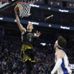 
              Golden State Warriors guard Donte DiVincenzo (0) shoots against Washington Wizards forward Corey Kispert, right, during the first half of an NBA basketball game in San Francisco, Monday, Feb. 13, 2023. (AP Photo/Jed Jacobsohn)
            