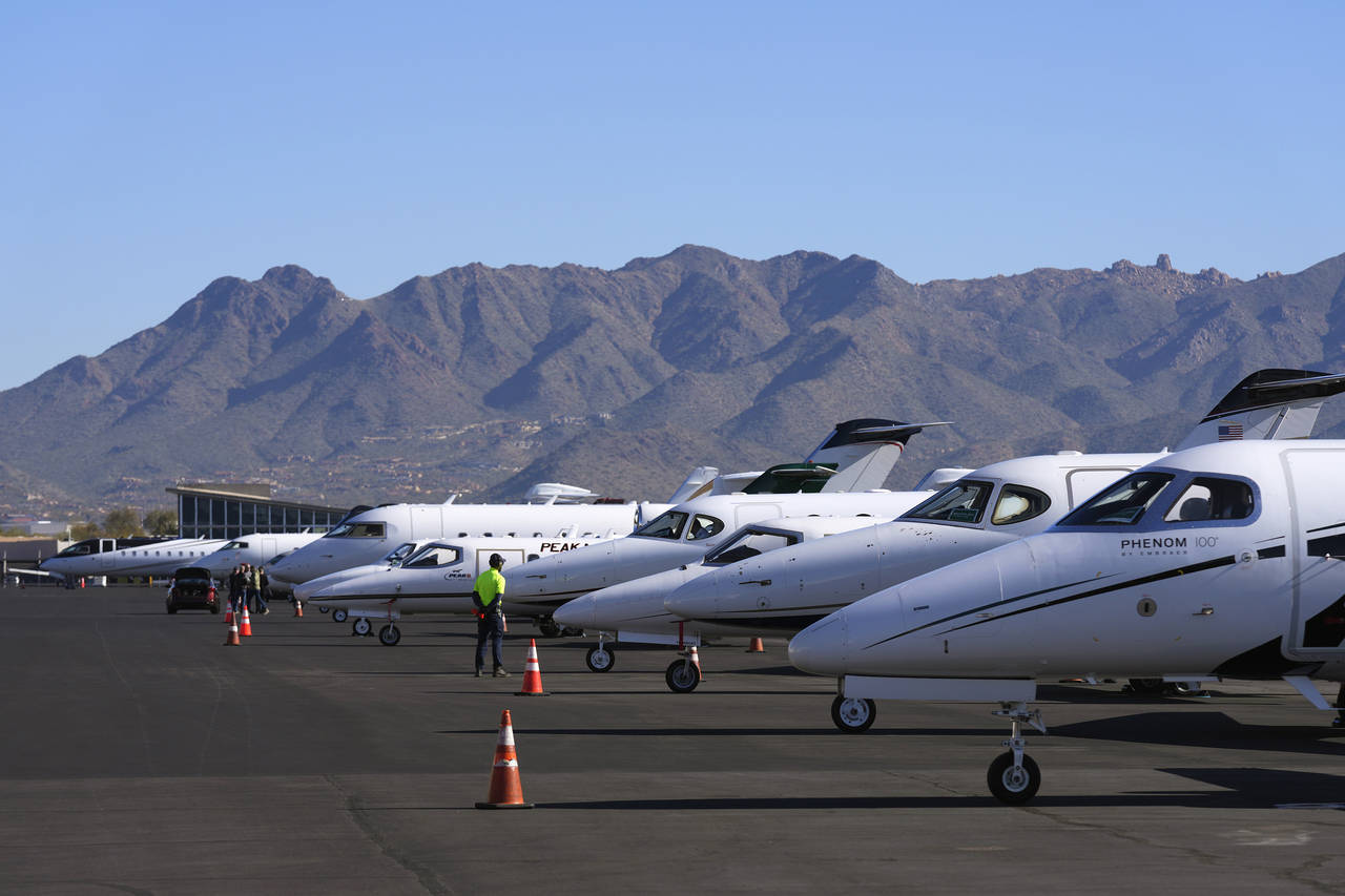 A Scottsdale Airport staffer waits on a private jet, as the airport gears up for the expected drama...