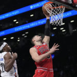 
              Chicago Bulls center Nikola Vucevic (9) goes to the basket past Brooklyn Nets center Day'Ron Sharpe (20) during the second half of an NBA basketball game, Thursday, Feb. 9, 2023, in New York. (AP Photo/Mary Altaffer)
            