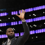 
              Los Angeles Lakers forward LeBron James waves to fans during a ceremony honoring him as the NBA's all-time leading scorer before an NBA game against the Milwaukee Bucks on Thursday, Feb. 9, 2023, in Los Angeles. James passed Kareem Abdul-Jabbar to earn the record during Tuesday's NBA game against the Oklahoma City Thunder. (AP Photo/Mark J. Terrill)
            