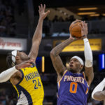 
              Phoenix Suns forward Torrey Craig (0) shoots while being defended by Indiana Pacers guard Buddy Hield (24) during the second half of an NBA basketball game in Indianapolis, Friday, Feb. 10, 2023. (AP Photo/Doug McSchooler)
            