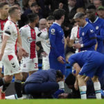 
              Players get around injured Chelsea's Reece James during the English Premier League soccer match between Chelsea and Southampton at the Stamford Bridge stadium in London, Saturday, Feb. 18, 2023. (AP Photo/Kirsty Wigglesworth)
            